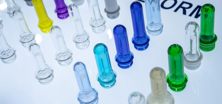 PET plastic bottle preforms before blow molding. Packaging industry. PET preforms from preforms injection molding machine. Raw material for PET bottle. Recycle plastic. Polyethylene terephthalate.