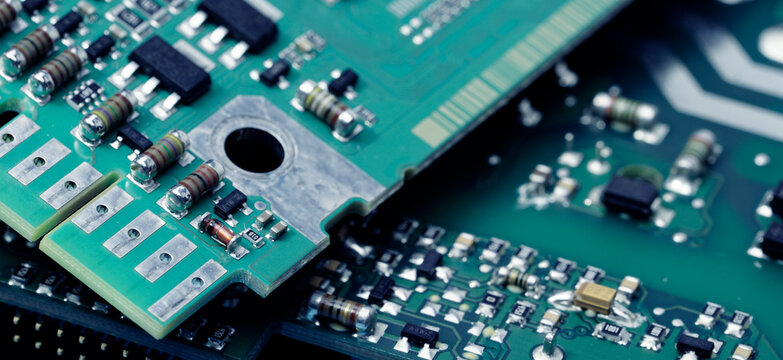 Close-up of a printed circuit board or PCB featuring wiring and microchip components. Advanced technology, precision engineering, and electronic hardware for modern devices and systems. PCB design.