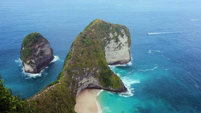 Kelingking Beach, located on Nusa Penida island, Bali, Indonesia.  Famous for a rock formation that looks like a Tyrannosaurus Rex. Beautiful blue ocean and iconic cliff formation. 