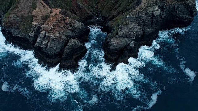 Static Aerial View of Dramatic Coastal Geometry with Crashing Ocean Waves in a Cinematic Style
