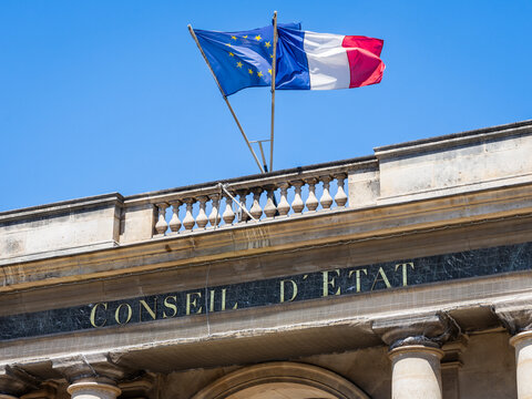 Paris, France - June 17, 2026: Low angle view of the sign on the portico at the entrance of the Council of State, decked with french and European Union flags, located in the Palais Royal.