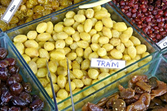 Glass containers of preserved Tram fruits at a local product fair in Vinh Long Vietnam