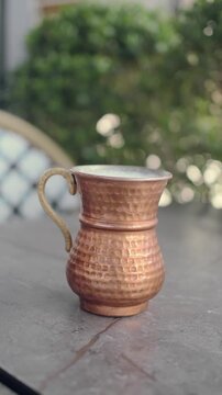 hand holding copper ayran cup