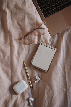 Minimalist home office essentials placed on soft fabric