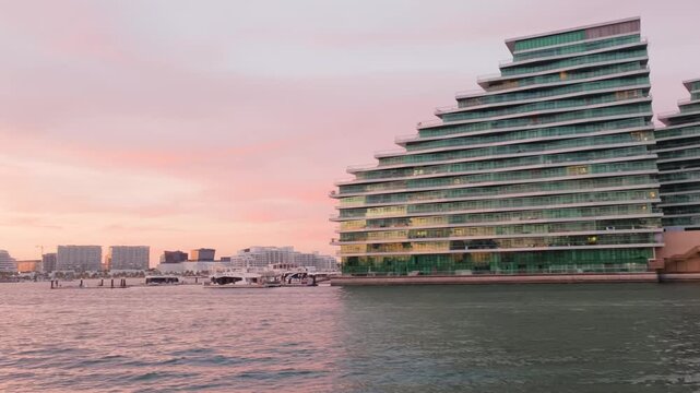 Modern waterfront architecture at Al Raha Beach, Abu Dhabi during sunset