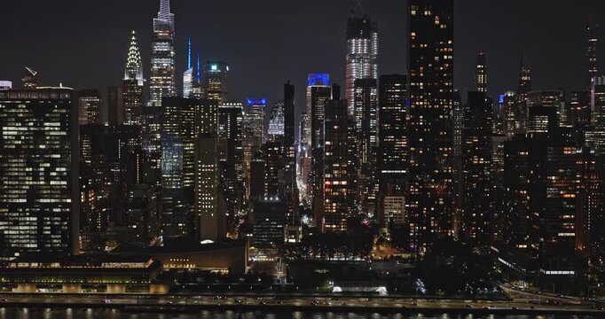 NYC New York Aerial v176 tracking flyover and along East river capturing traffics on FDR drive and illuminated skyscrapers cityscape of Midtown Manhattan - Shot with Inspire 3 8k - September 2023