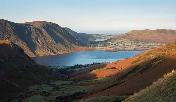 Views over Crummock Water to the summit of Mellbreak from Grasmoor early on a winters morning in Cumbria, Lake District, England UK.