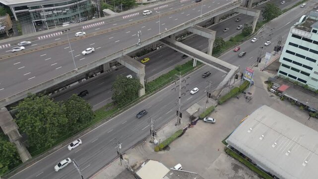 Vehicles Move Along Highway And Underpass In Bang Na Bangkok Thailand Drone Track Back 4K 60FPS