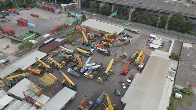Cranes Parked In Yard Truck Pulls Away Bang Na Bangkok Thailand Drone Circling 4K 60FPS