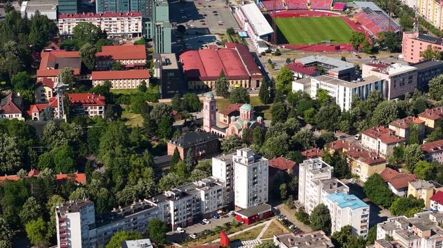 Banja Luka, Bosnia and Herzegovina. Drone Shot of Holy Trinity Orthodox Church by Stadium and Residential Buildings