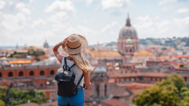 Rome Europe Italia travel summer tourism holiday vacation background -young smiling girl with mobile phone camera and map in hand standing on the hill looking on the cathedral Vatican