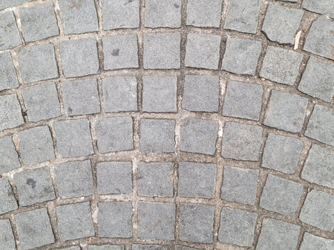 a classic cobblestone or interlocking paver surface arranged in a distinct fan-shaped or arched design