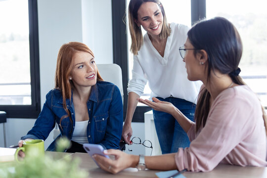 Businesswomen using smartphone during meeting in an office