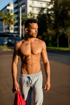 Portrait of a muscular man with bare chest, after workout