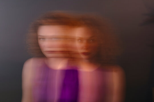 Portrait of red-haired woman, blurred, double