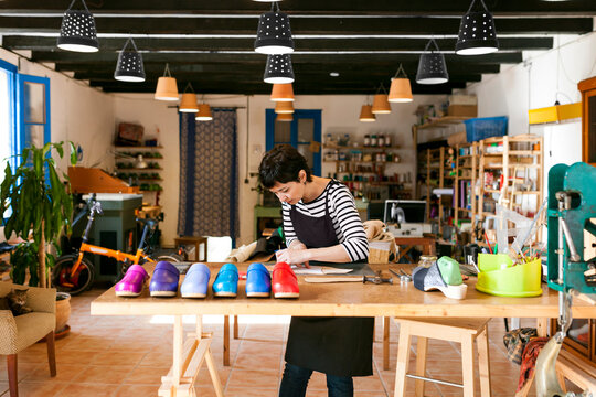 Clogmaker working in her workshop