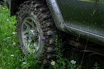 Muddy off road car wheel close up © solidmaks