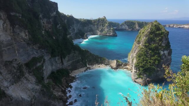 A slow motion shot of Diamond Beach (Pantai Diamond)  in Nusa Penida, Bali, Indonesia. Shot from near Thousand Islands Viewpoint looking down on the white shores, dramatic limestone cliffs and crystal