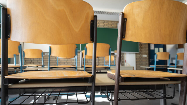 School closed - Empty classroom with chairs stacked on the desks