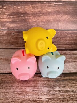 Three colorful piggy banks representing family savings, budgeting and financial planning concept