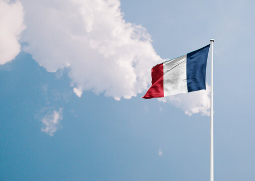 France national flag waving in sky with long mast.