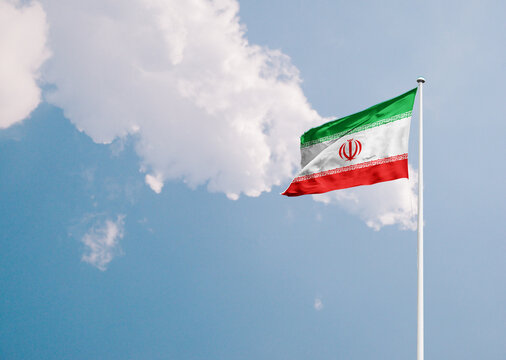 Iran national flag waving in sky with long mast.
