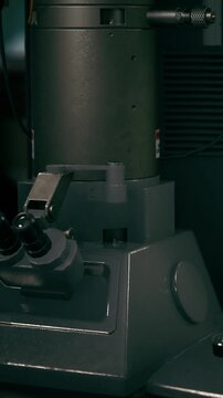 A laboratory machine sits on a workbench in a research facility. The device is designed for various scientific experiments. It is an important tool for researchers.