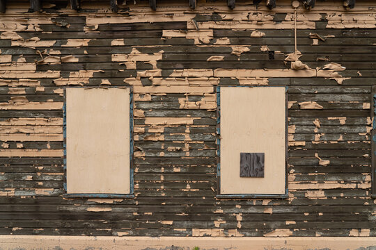 boarded windows on old weathered wooden building