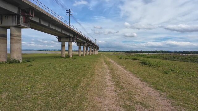 The vdo shows the railway bridge piers at the Pa Sak Dam in Thailand, which are visible up close during the dry season.