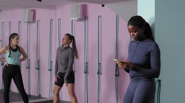 African american female coach observing fitness class
