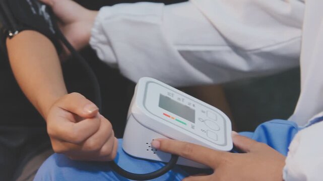 The Asian doctor used a blood pressure monitor and a heart rate monitor with a digital pressure gauge.