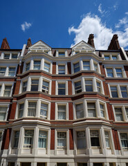 Fototapeta premium London - 07 14 2022: Torrington Place red‑brick façade with white architectural trim