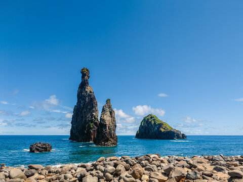 Spectacular rock formations rising from the blue Atlantic Ocean waters near the coast of Ribeira da Janela, Madeira, Portugal