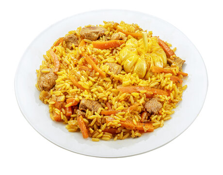 White plate of traditional uzbek lamb pilaf with garlic isolated on a white background. Traditional asian food.