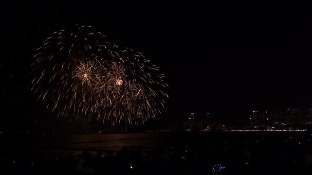 Golden Fireworks Display Exploding Over The Dark Sea And Pattaya City Skyline During A Night Festival In Chon Buri Thailand