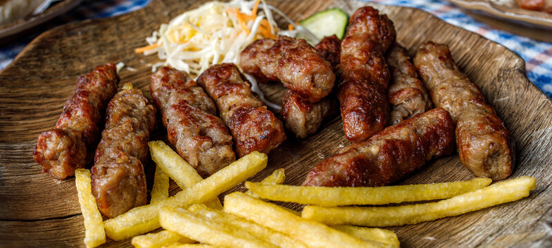 Enjoying cevapi with fries at a local restaurant in the afternoon