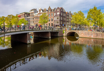 Obraz premium Typical Dutch architecture and bridges over Amsterdam canals, Netherlands
