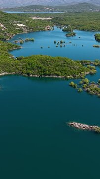Vertical Drone Shot of Slano Lake Rugged Coastline, Green Landscape and Water Reservoir, Montenegro