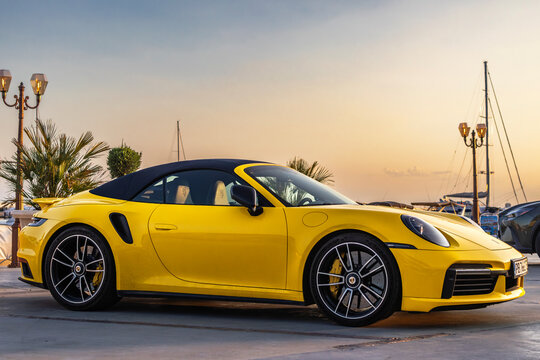 Marina Dinevi, Sveti Vlas, Burgas, Bulgaria - July.06.2026: Yellow convertible Porsche 911 Turbo S parked at the Marina Dinevi yacht port in Sveti Vlas at sunset