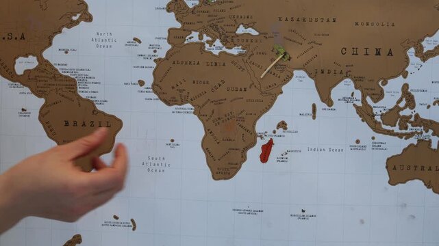 Human hand bringing fire to Iran on a world map symbolizing how political decisions can ignite armed conflicts escalate global tensions and threaten international peace