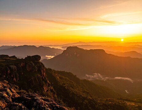 Majestic mountain range bathed in the warm glow of a golden sunrise.
