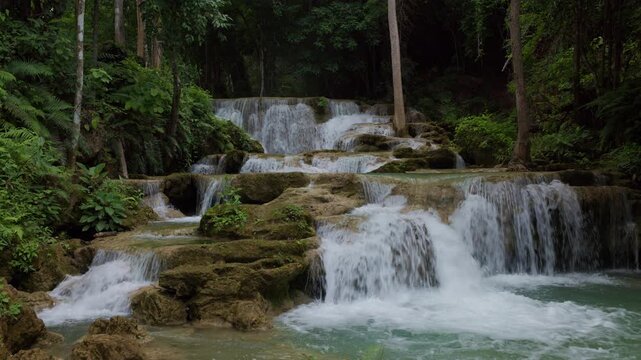 Turquoise Water Cascading Over Tiered Limestone Rocks In A Lush Tropical Rainforest At Huai Mea Khamin Waterfall Kanchanaburi Thailand