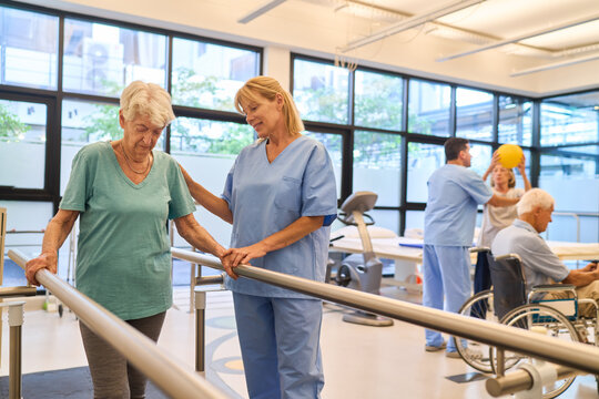 Elderly woman receiving physical therapy assistance in a rehabilitation facility