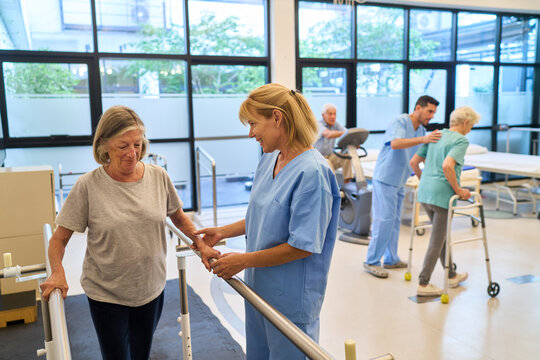 Healthcare workers assisting seniors in a rehabilitation facility