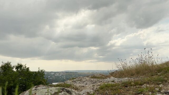 Thick storm clouds drift over the rocky hills of Simferopol, Crimea. The dramatic sky creates a gloomy yet deeply peaceful mood.