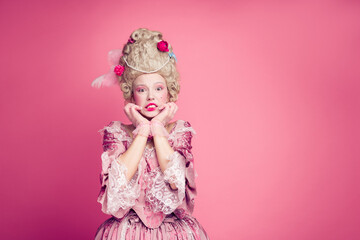 Fototapeta premium Photo of anxious lady princess bite finger nails feel fear wearing medieval style dress costume isolated pink color background