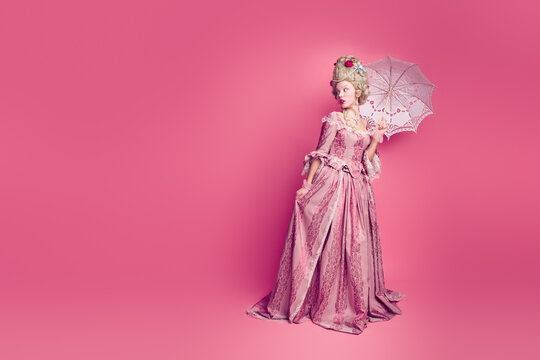 Full length photo of impressed shockes lady dressed baroque costume holding parasol looking copy space isolated pink color background