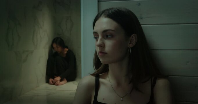 Depressed woman sit bathroom wall, sad girl cry inside shower bath room. Female lesbian couple quarrel ignoring problem. Sisters relationship crisis, misunderstanding, loneliness, conflict break up.