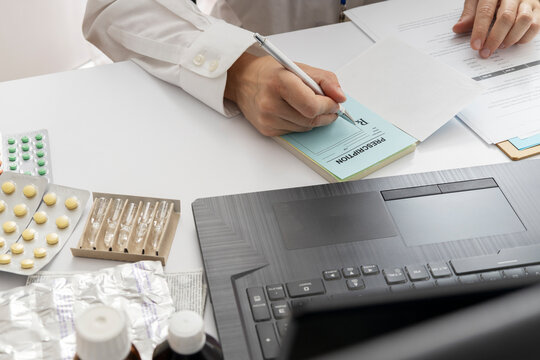 Healthcare Consultation and Writing Prescription for Medicine. Doctor writing a prescription for medicine, cheking information about parient and desease