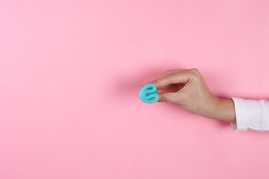 Close Up Of Adult Female Demonstrates Folding Silicone Menstrual Cup